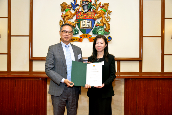 Ms. Mavis Chan (right) receiving a Certificate of Appreciation from Ir. Ricky Lau, JP (left)